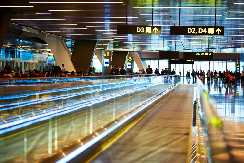 Travel, airport and terminal for departure or arrival with boarding gate, signage or passenger for immigration. Walkway, path and people in waiting area for international flight or delay in flight.