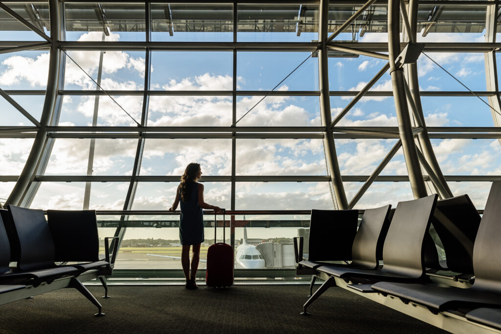 Young girl travel walking with carrying hold suitcase in the airport. Tourist Concept.